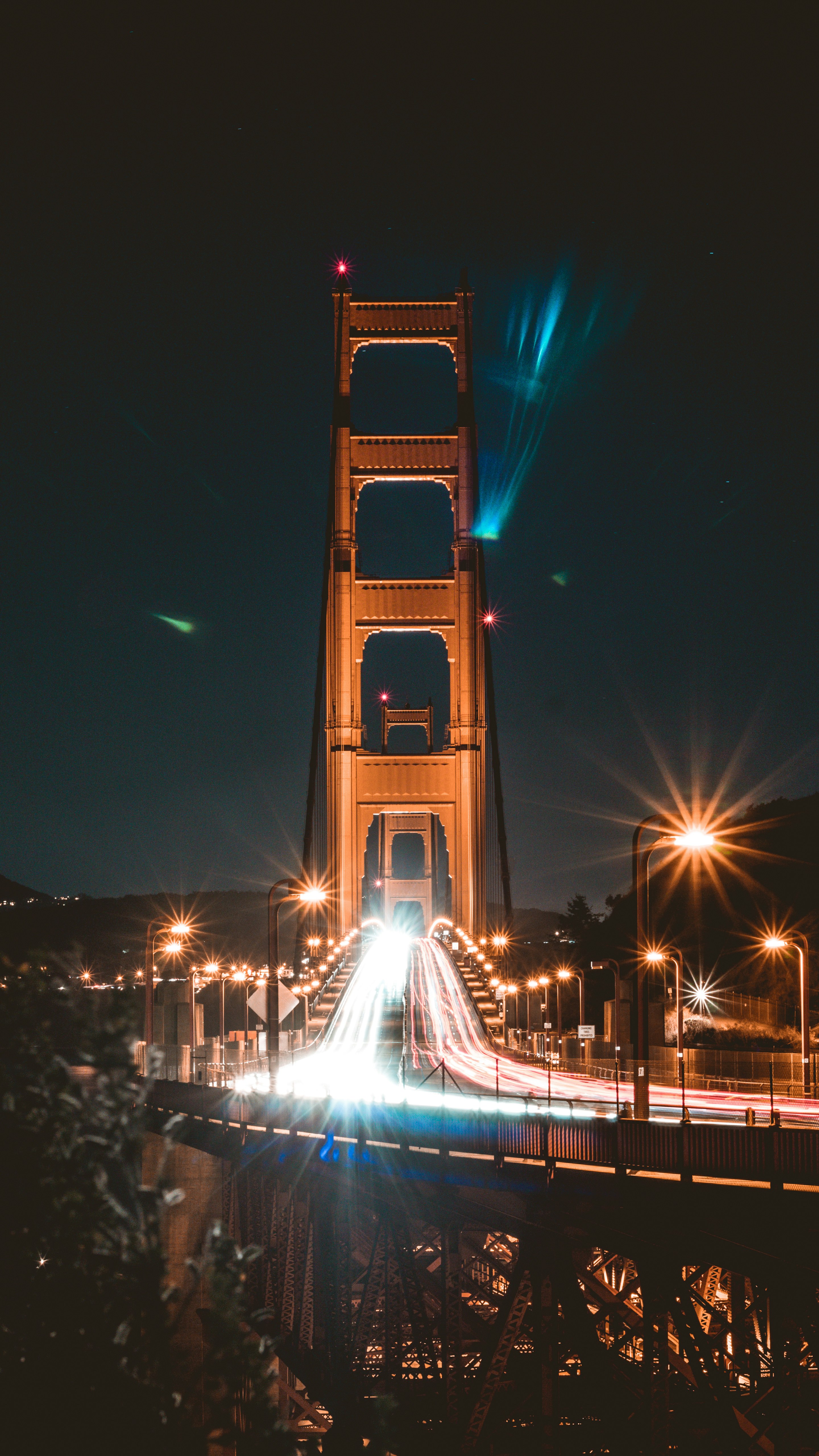 cars passing Golden Gate Bridge during night time